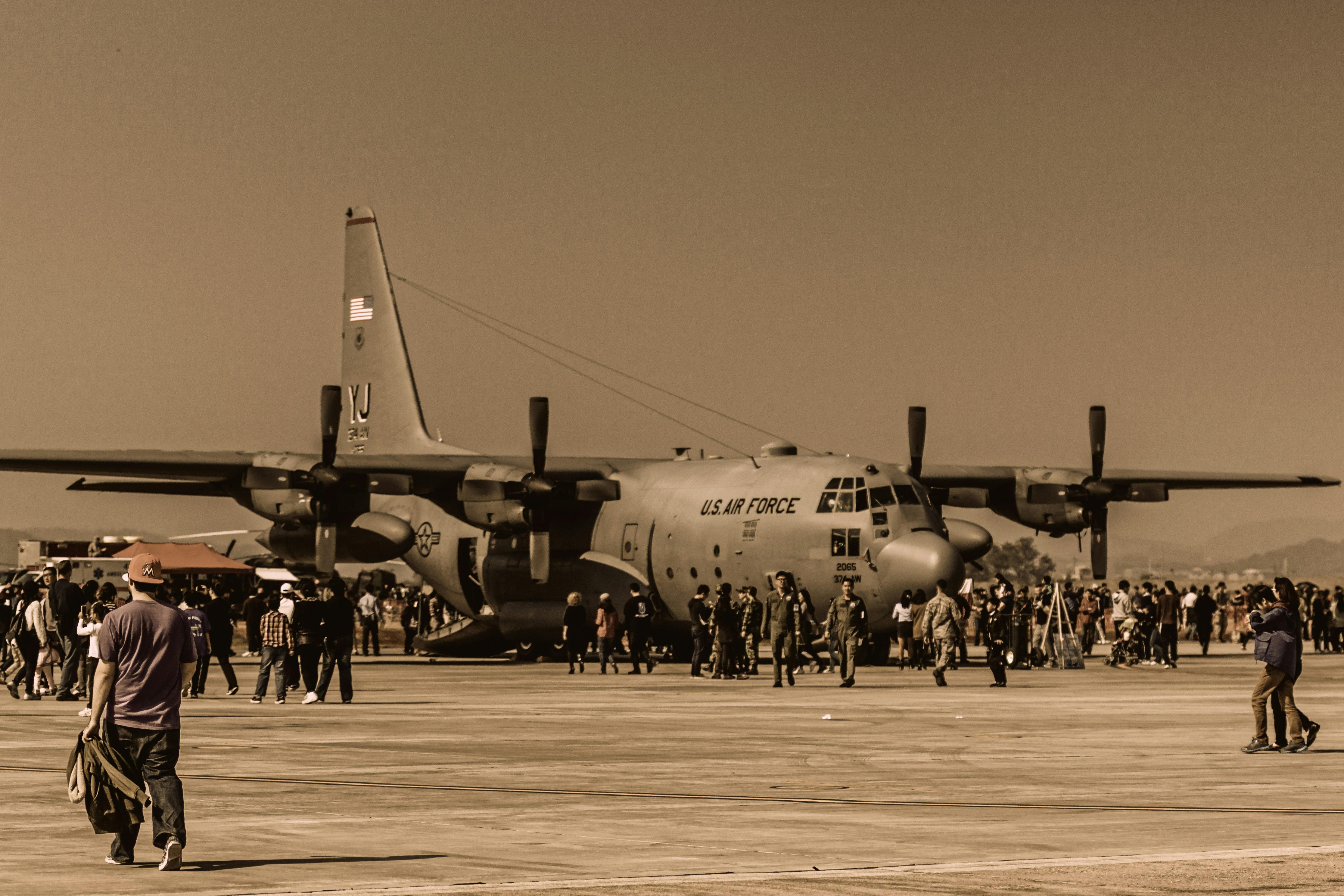 black and white jet plane on gray field during daytime